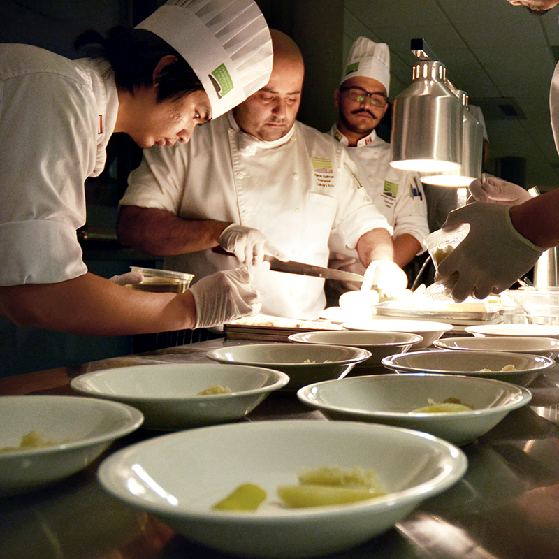 Chefs in the kitchen plating food